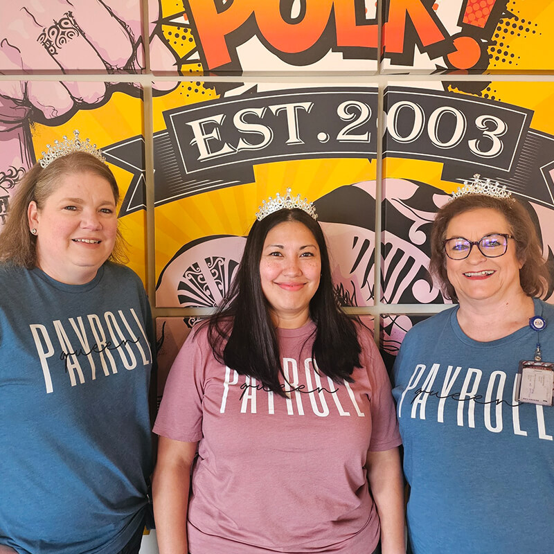 NPW Celebrate in Your Company Gallery 6 Three women smiling while wearing tiaras.